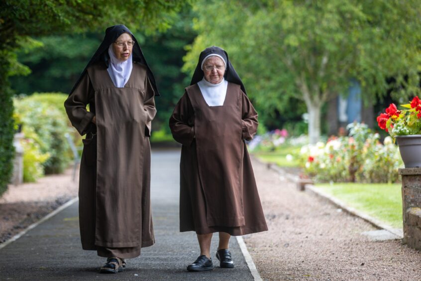 Sister Teresa strolls through the gardens of Dysart House with Sister Mary Theresa.