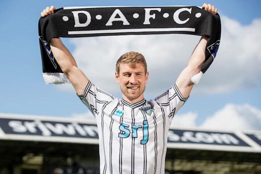 David Wotherspoon holds a Dunfermline Athletic scarf above his head after signing for the Pars