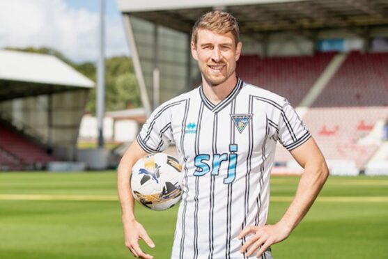 New Dunfermline Athletic FC recruit David Wotherspoon wears a Pars top and holds a football at East End Park. Image: Craig Brown/Dunfermline Athletic FC