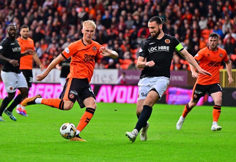 Dundee United's Owen Stirton gets ahead of Gregor Buchanan to rattle the bar.