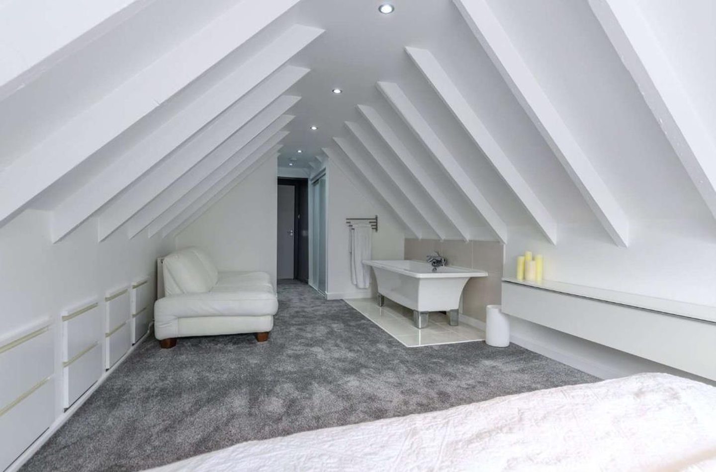 A bathtub and seating area in bedroom one.