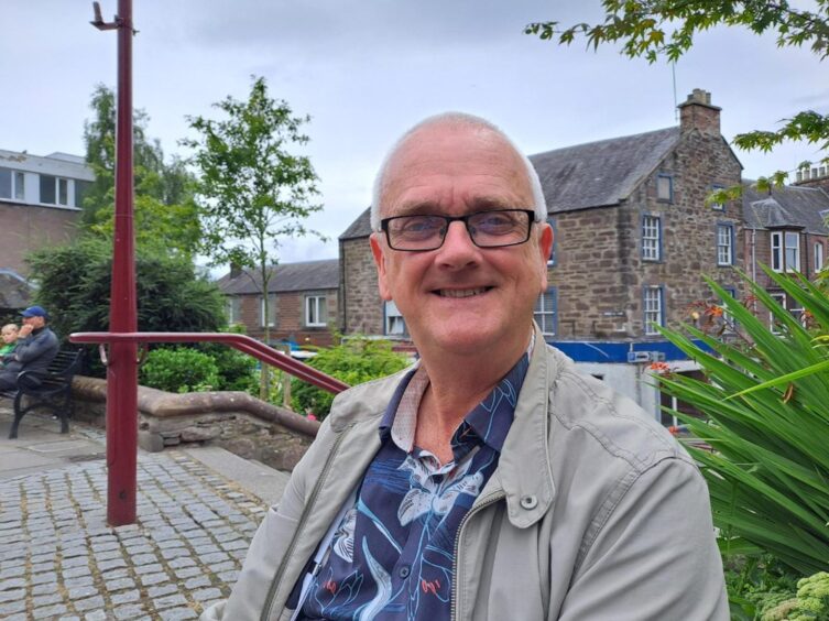 Kenneth Norrie smiling in James Square, Crieff