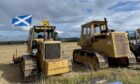 Vintage diggers with Scotland flag flying from one