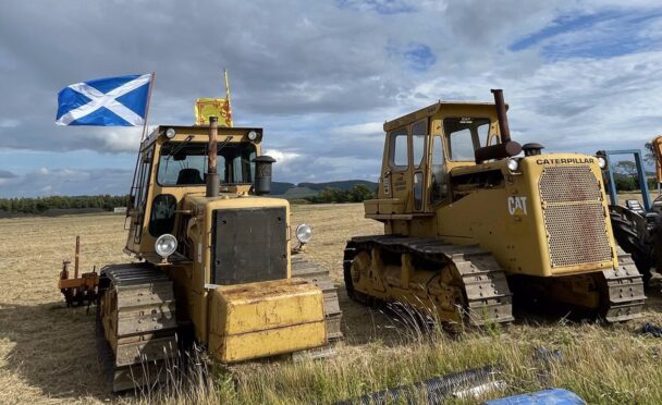 Vintage diggers with Scotland flag flying from one