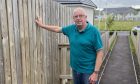 John Burgess at the fence which Perth and Kinross Council want removed.