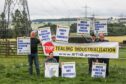 Stop Tealing Industrialisation Group members hold up placards protesting SSEN plans for a new substation. L-R: Robin Kemlo, Karolina Hain, Alison Wiseman, Graham Sutherland and John Wiseman. Image: Mhairi Eddwards/DC Thomson.