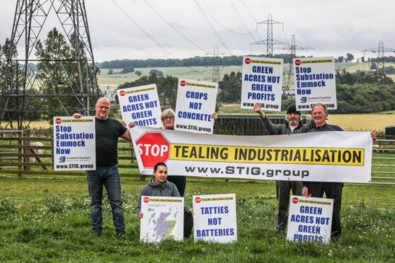 Stop Tealing Industrialisation Group members hold up placards protesting SSEN plans for a new substation. L-R: Robin Kemlo, Karolina Hain, Alison Wiseman, Graham Sutherland and John Wiseman.