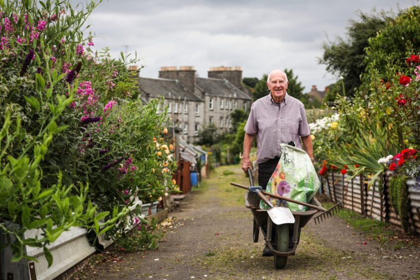 John Stoa walks through the City Road Allotments.