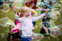 Pippa McKay, 7, surrounded by bubbles at DEBRA Fest. Image: Mhairi Edwards/DC Thomson