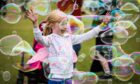 Pippa McKay, 7, surrounded by bubbles at DEBRA Fest. Image: Mhairi Edwards/DC Thomson