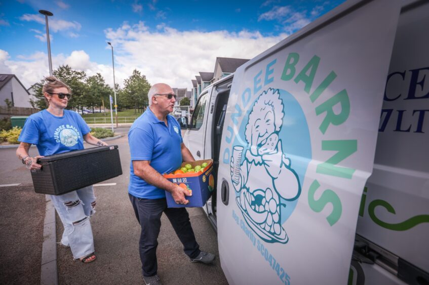 Dundee Bairns Project worker Susan Maxwell and Chairman David Dorward fill the van with food for kids. 