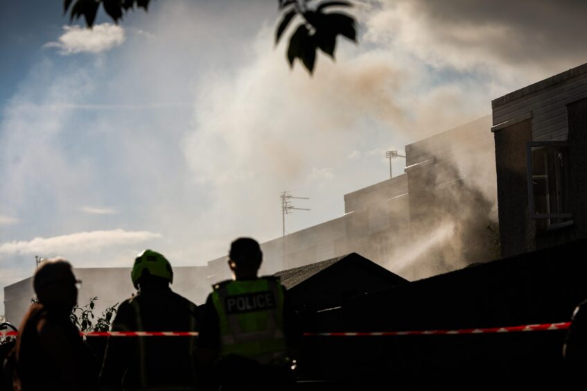 Smoke rising from the house on Linfield Street. 