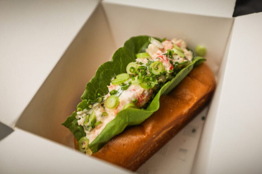 A lobster roll from the St Andrews seafood shack, inside a white takeaway box. 