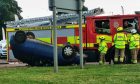 The overturned car at the Scott Fyffe Roundabout in Dundee.