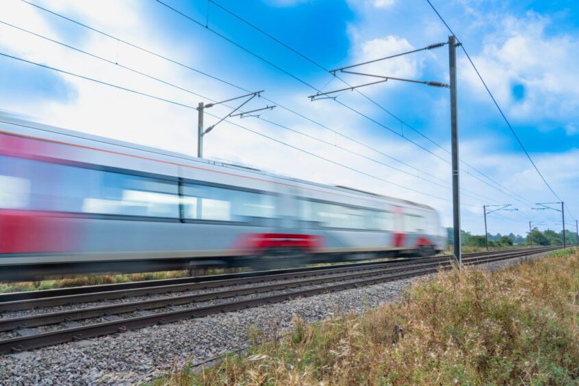 Train passing in a blur on railway tracks