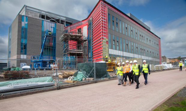 Deputy First Minister Kate Forbes, Dr David McBeth (Dundee University) and Adrian Gillespie, chief executive of Scottish Enterprise tour the innovation hub construction site on Hawkhill.  Image: University of Dundee