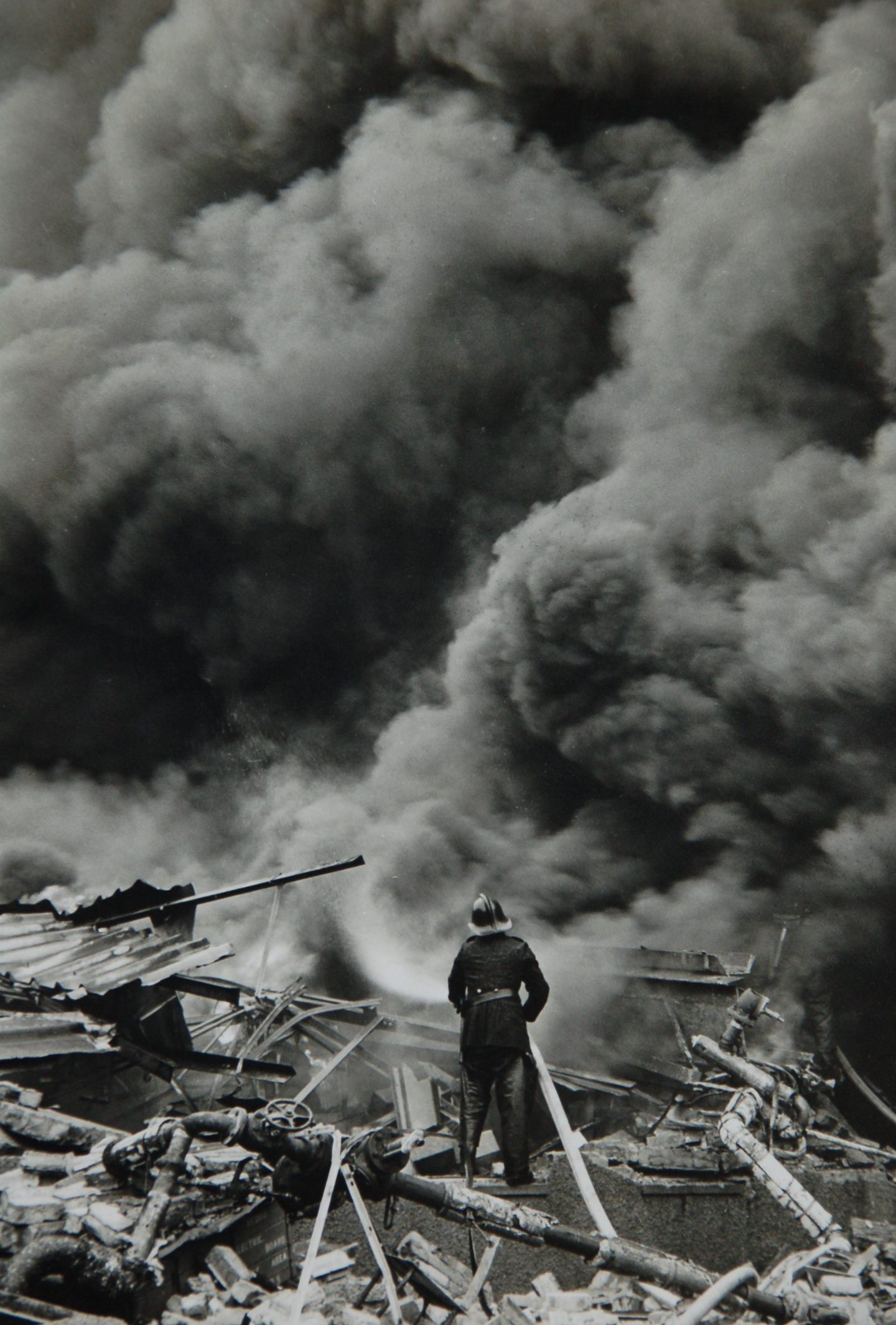 A firefighter in front of a huge plume of smoke during the fire at Timex in 1966