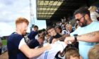 Simon Murray signs autographs for Dundee fans at Dens Park. Image: David Young