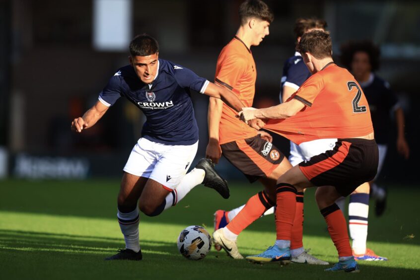 Dundee B striker Rayan Mohammed and United B defender Sean Borland battle for the ball. Image: David Young