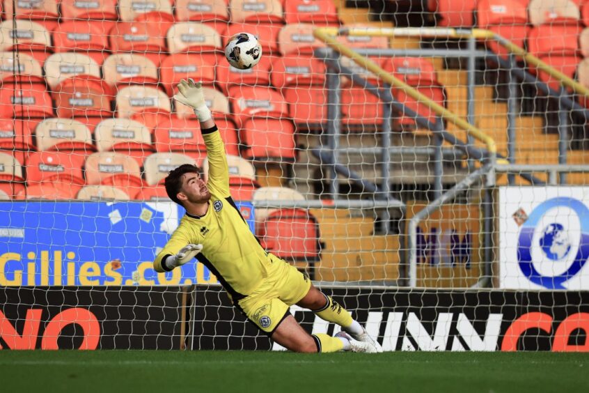 Dundee United B goalie Ruairidh Adams pulls off a super save to deny Dundee's Jamie Richardson from the spot. Image: David Young