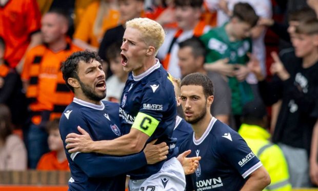 Luke McCowan enjoys his derby equaliser for Dundee. Image: Shutterstock