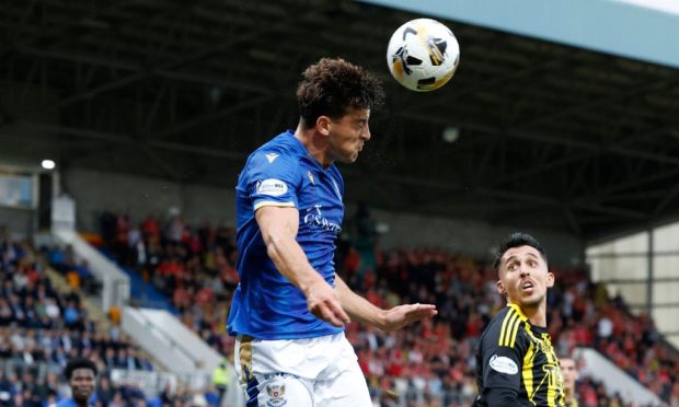 Lewis Neilson wins a header against Aberdeen.