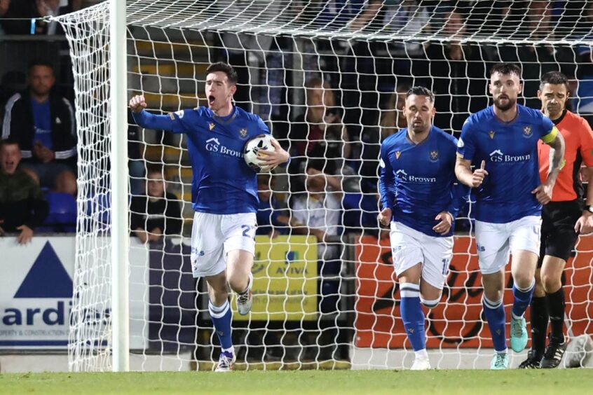 Makenzie Kirk holds the ball and punches the air after St Johnstone score against Aberdeen FC