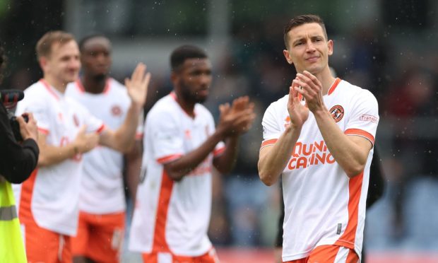 Dundee United favourite David Babunski leads the applause for the away fans