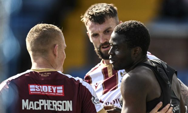 Benji Kimpioka is congratulated after scoring his penalty.