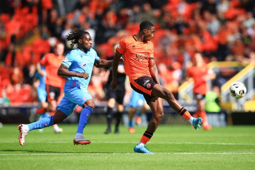 Emmanuel Adegboyega plays out of defence for Dundee United 