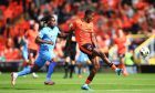 Emmanuel Adegboyega plays out of defence for Dundee United