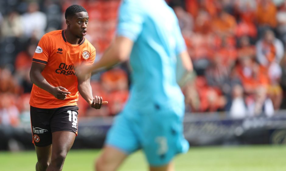 Dundee United defender Emmanuel Adegboyega strides out of defence