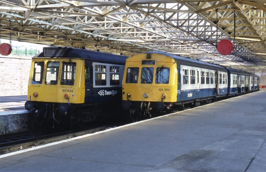 Diesel Multiple Units side by side at Dundee train station. 