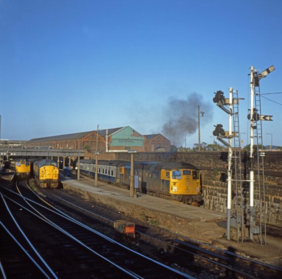 A busy scene with diesel trains on the tracks at Dundee station in the early 1980s. 