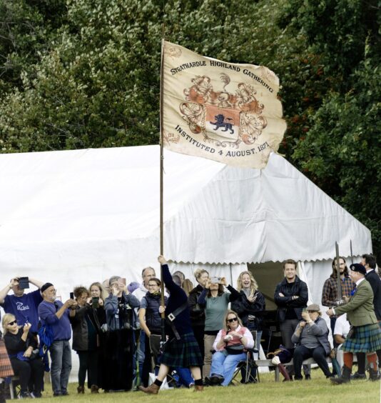 Strathardle Highland Games banner from 1871 is paraded to signal the start of the event. 