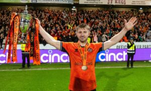 Ross Docherty holds aloft Dundee United's Championship trophy last season. Image: Paul Devlin/SNS