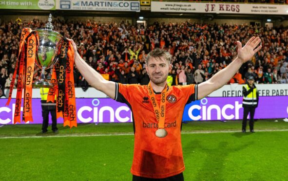 Ross Docherty holds aloft Dundee United's Championship trophy last season. Image: Paul Devlin/SNS