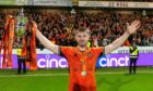 Ross Docherty holds aloft Dundee United's Championship trophy last season