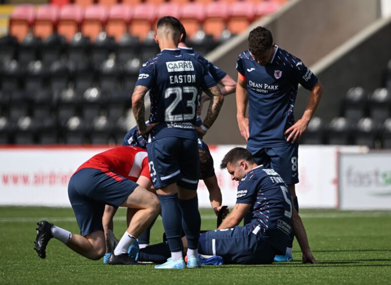 Raith defender Callum Fordyce receives treatment for an ankle injury.