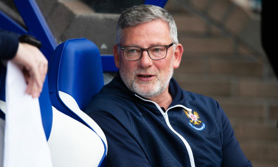 St Johnstone manager Craig Levein sitting in a dugout seat