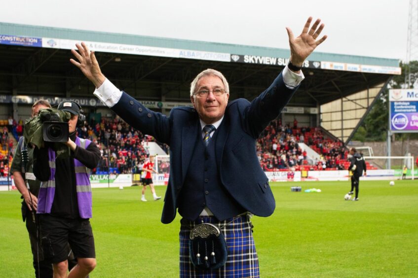 Geoff Brown in kilt, arms raised on pitch at St Johnstone FC stadium