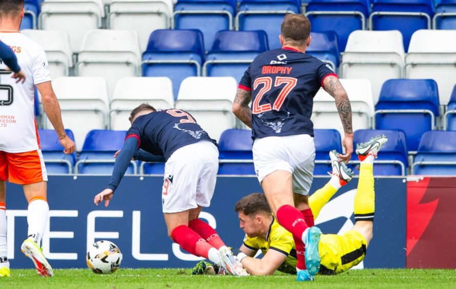 Dundee United's Jack Walton trips Ronan Hale in the box.