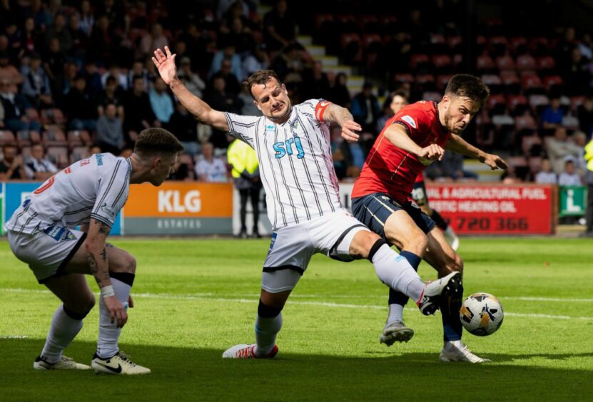 Pars skipper Kyle Benedictus puts in a tackle against Falkirk as team-mate Sam Fisher looks on.