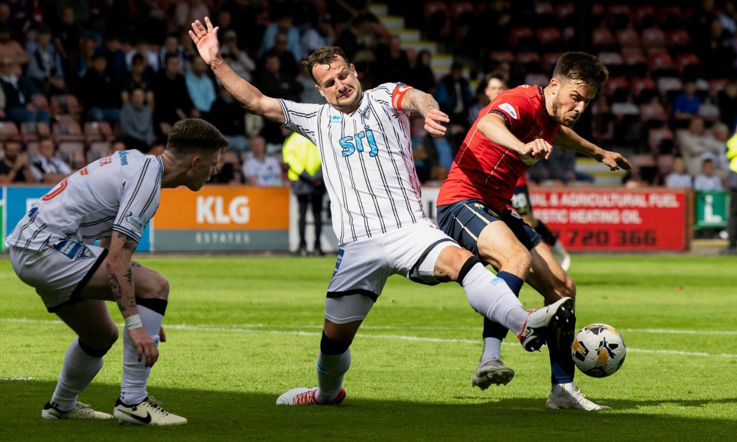 Dunfermline captain Kyle Benedictus and Falkirk striker Ross MacIver battle for possession.