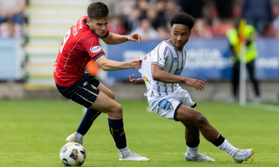 Dunfermline's Kane Ritchie-Hosler is pulled back by Ross MacIver in the 2-0 defeat to Falkirk.