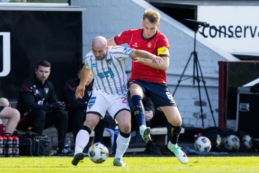 Chris Kane gets a pass away under pressure from Bairns skipper Coll Donaldson.