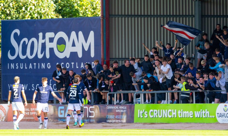 Dundee players celebrate with the fans against Hearts. Image: SNS