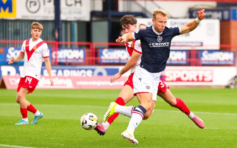 Dundee's Curtis Main flicks in a brilliant finish against Airdrie. Image: SNS