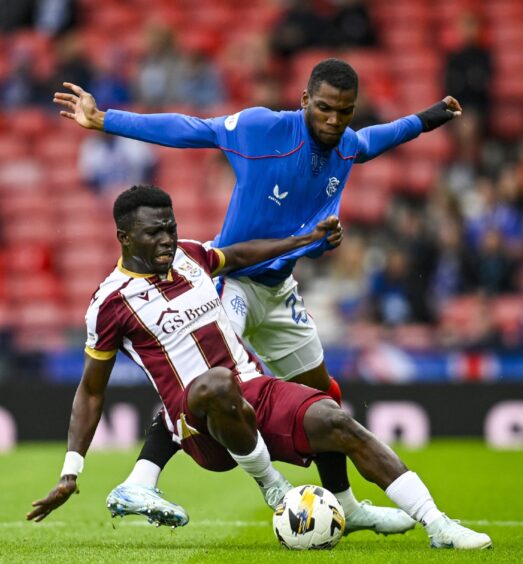 Adama Sidibeh wins a sliding tackle for St Johnstone in their Scottish Premiership game against Rangers