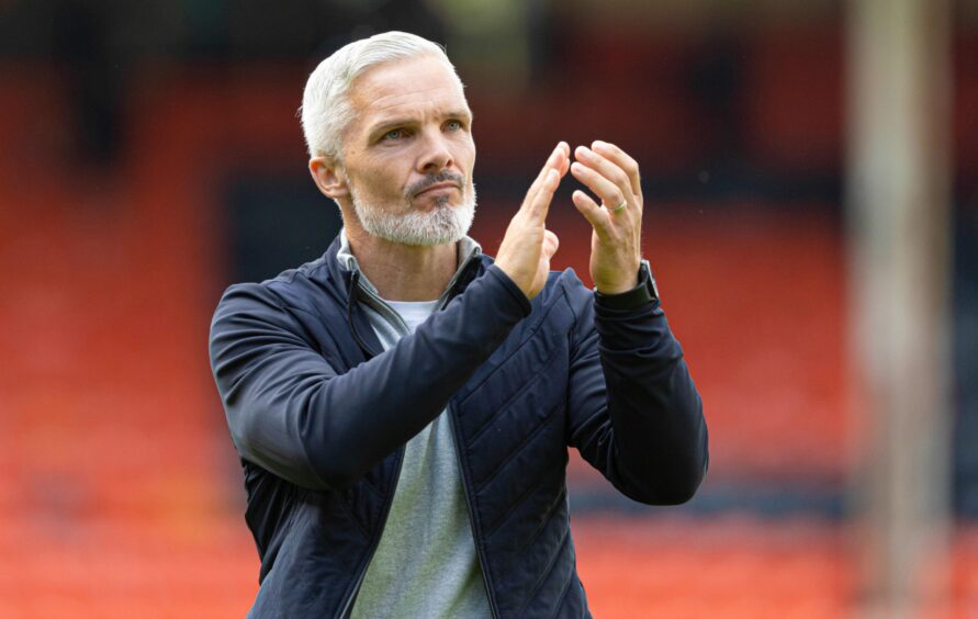 Jim Goodwin salutes the Dundee United fans after seeing off St Mirren